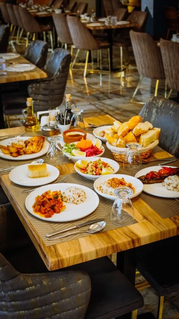 A beautifully arranged restaurant table showcasing a variety of delicious meals ready to be served.
